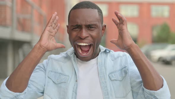 Outdoor Portrait of African Man Screaming Shouting