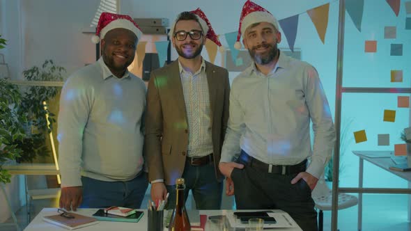 Portrait of Businessmen Standing in Decorated Office During Christmas Party Smiling