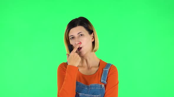 Woman with TV Remote in Her Hand, Switching on TV. Green Screen