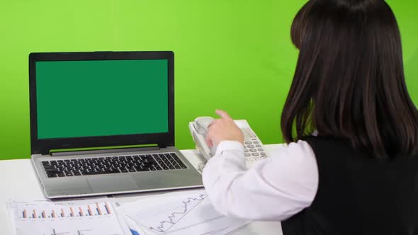 Green Screen Laptop on a Desk Office Worker Woman. Studio