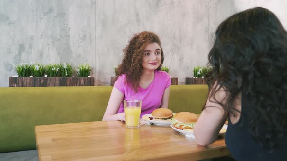 Two Female Friends Talking in Cafe