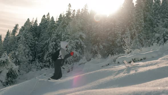 A Young Woman is Going Out on a Snowcovered Mountain