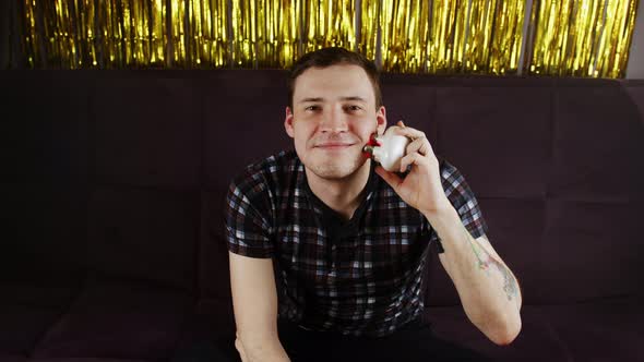 Young Happy Man Using 3d Massager for Face