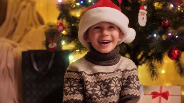 Happy Laughing Boy Shaking His Head with Santa Hat