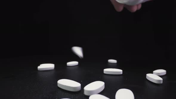 Pouring White Antiviral Drugs Onto Black Surface Close View