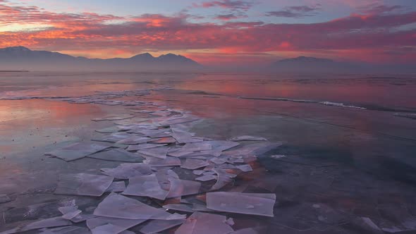 Color refection of sunrise over frozen lake in Utah