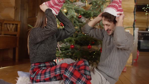 Couple putting on Christmas hats