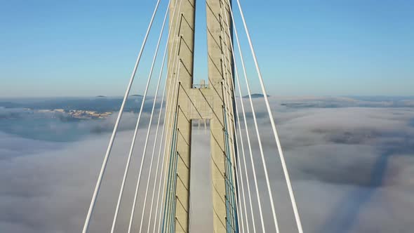 Flying Between the Cables of the Bridge Built Over the Sea Strait