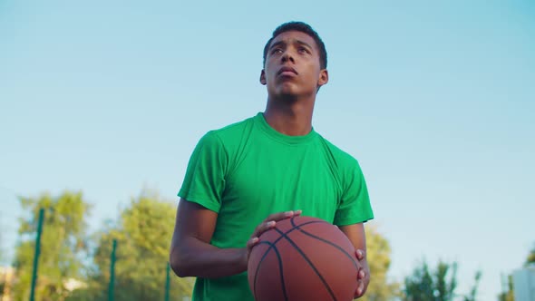 Basketball Player Shooting for Score Outdoors