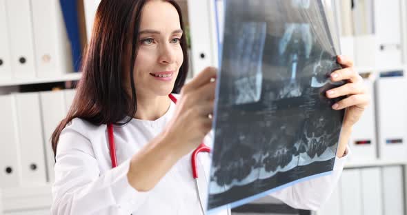 Woman Doctor Looking at Xray of Spine in Clinic  Movie Slow Motion