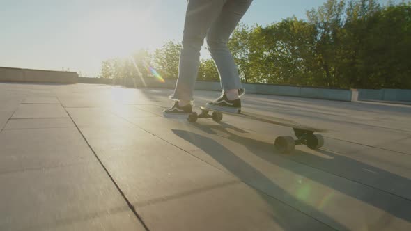 Female Skateboarder Skateboarding in City at Sunrise