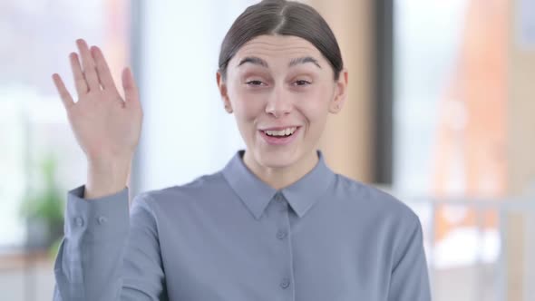 Portrait of Young Latin Woman Waving Welcoming