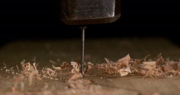 Hammer Pushing a Nail on a Board, Chips of Wood, Slow Motion 4K