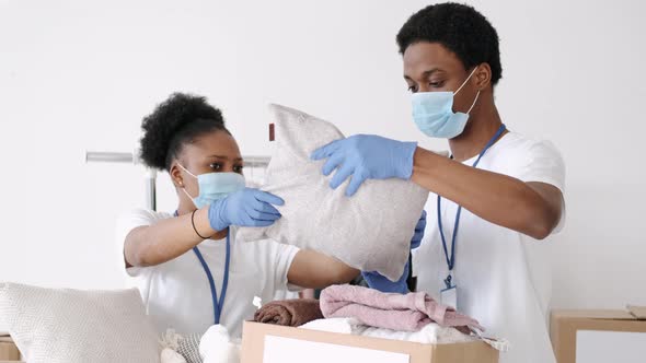 Volunteers Wearing Masks Sorting Clothes Donations During Pandemic