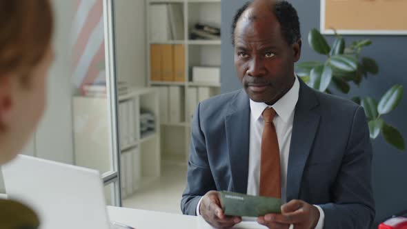 US Consular Officer Examining Passport of Visa Applicant