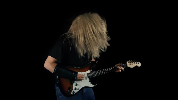 Heavy Metal Guitarist Playing Guitar And Headbanging