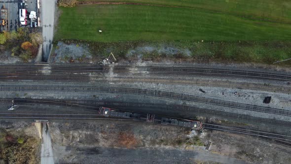 Aerial view of a train making a turn on the railway track.