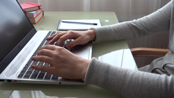 The girl working at home office hands on keyboard