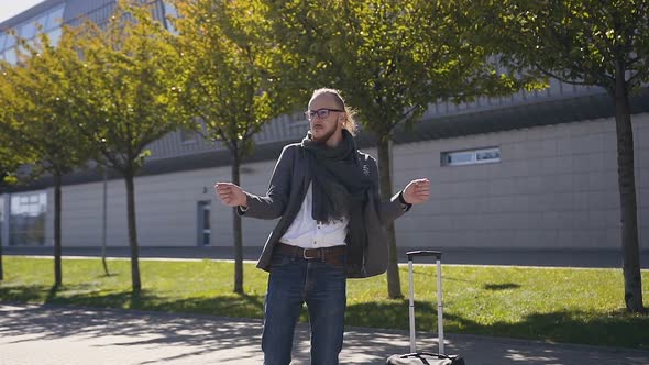 Crazy young and happy businessman is dancing in jacket 