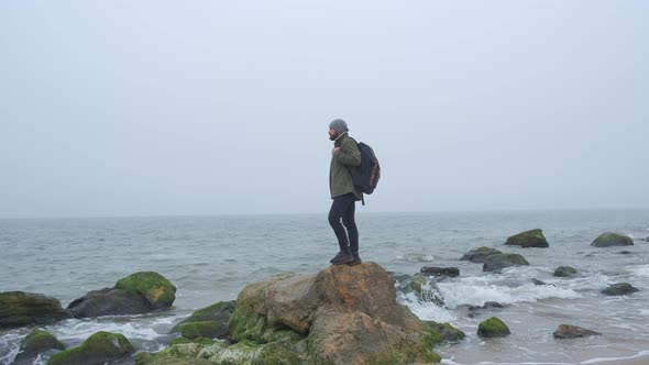 One Lone Tourist in the Wilderness with Stone Mountains and Coast