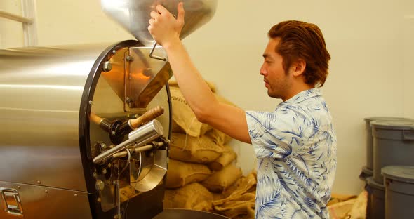 Man using coffee grinding machine