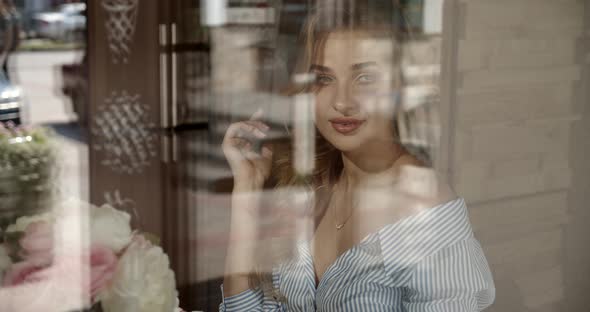 Girl Tenderly Smiling Sitting By The Window