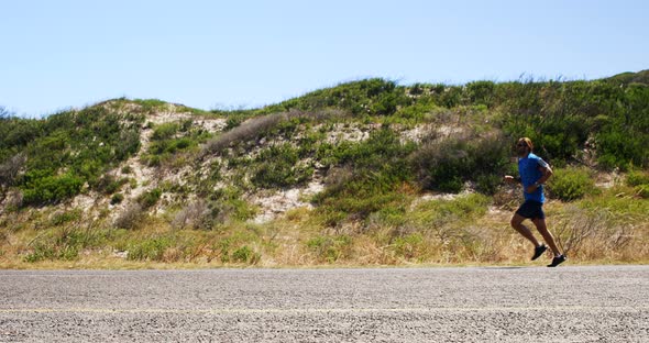 Triathlete man jogging in the countryside road