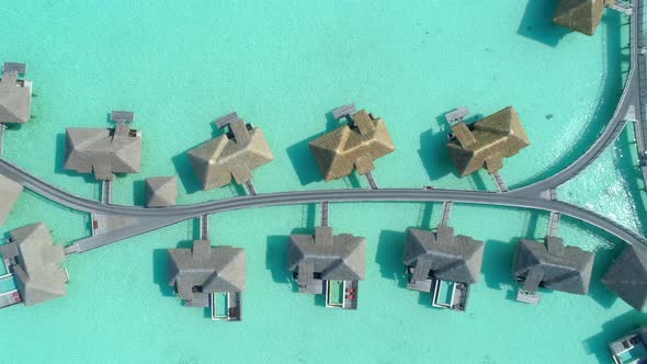 Aerial drone view of a luxury resort and overwater bungalows in Bora Bora tropical island