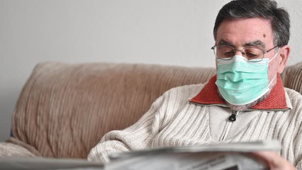 Elderly Man Reading Newspaper During Coronavirus Epidemic Quarantine