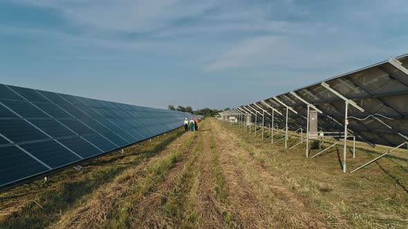 Top View of Specialists Walking Across a Solar Power Plant