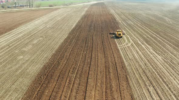 Tractor with Disc Harrows on the Farmland