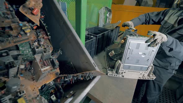 Male Worker Prepares TV for Recycling.