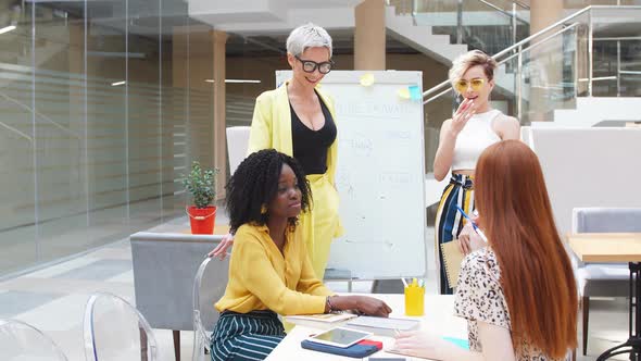 Red-haired Woman Consulting Her Colleagues