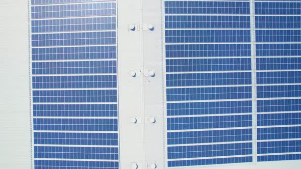 Aerial cinematic view of a solar panel on mall roof top