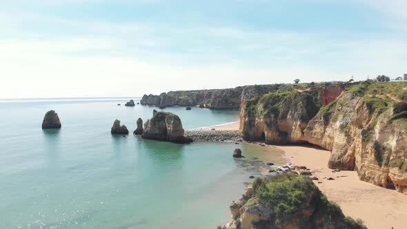 Slide view over empty Pinhão Beach in Lagos Coastline, Algarve, Portugal