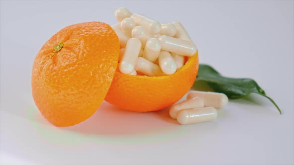 Vitamins C with Oranges on a White Background