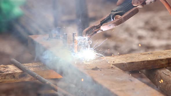 worker use electric welding for cutting hole and drill metal