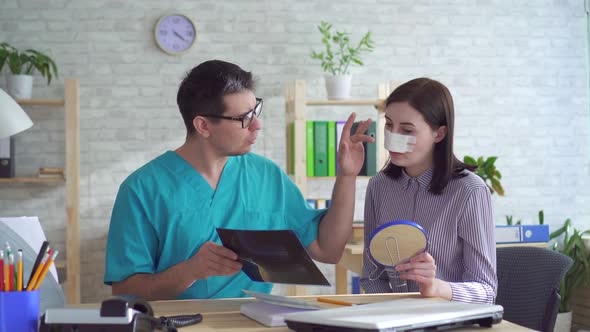 Doctor Plastic Surgeon Talks To a Young Woman After Plastic Surgery on the Face