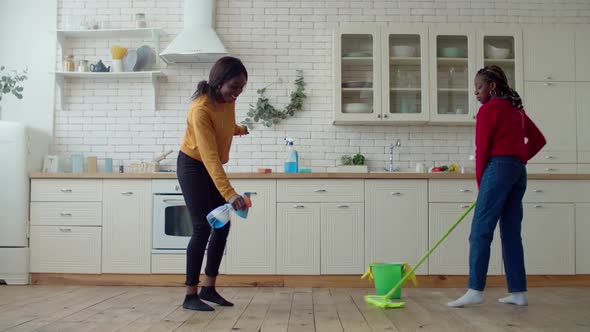 Annoyed Black Preadolescent Girls Mopping Floor