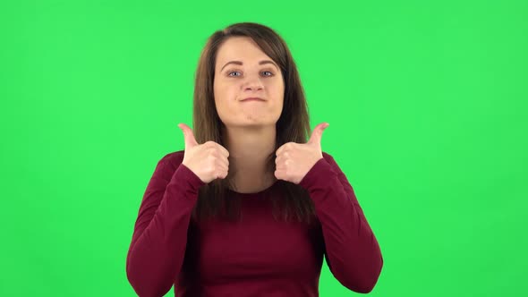 Portrait of Pretty Girl Showing Thumbs Up, Gesture Like. Green Screen