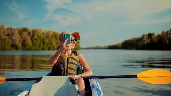 Girl Making Self Photo And Answer To Video Call. Holiday Vacation Trip On Weekend. Kayak Boat.