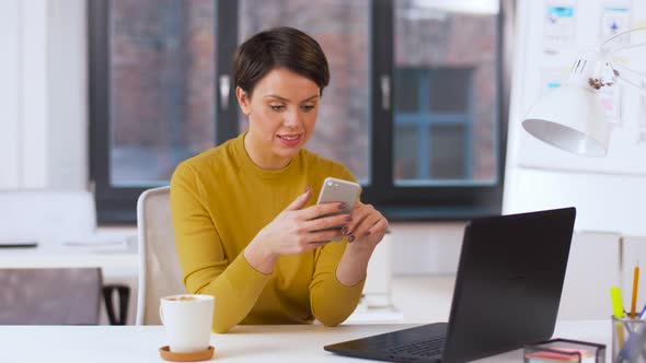 Smiling Businesswoman Using Smartphone at Office 5