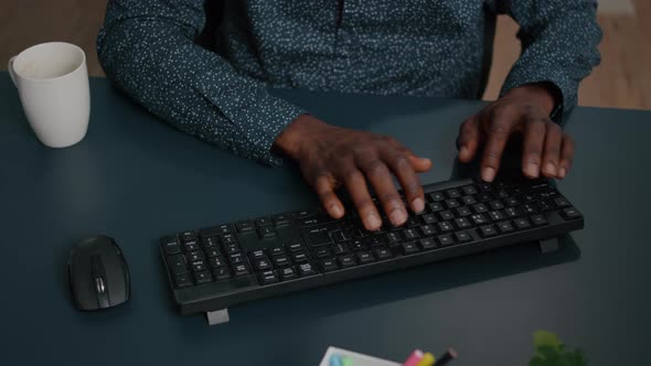 Black African American Person Typing on PC Keyboard