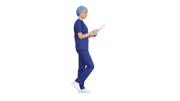 Female Professional Doctor or Nurse Reading Medical Form While Walking on White Background.