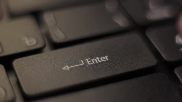 The Finger Presses the Enter Button on the Keyboard. Close-up.