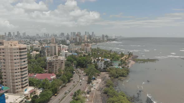 Drone dolly forward over sea facing city