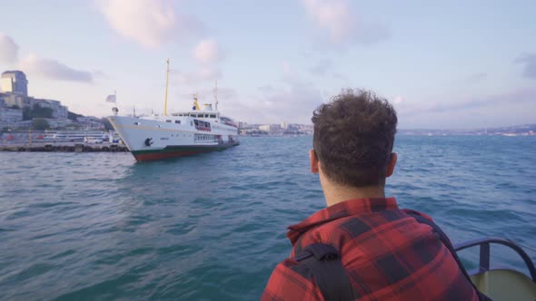 The man leaving the city by ferry.