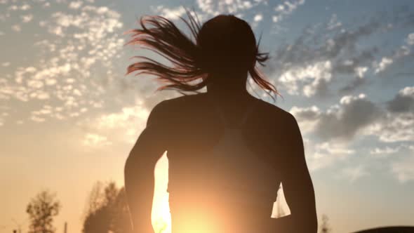 Woman Jogger Running Outdoor at Yellow Sunset Cloud Sky Enjoying Morning Physical Activity