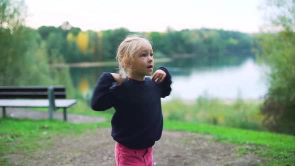 Cute Little Girl Doing Gymnastics in the Park