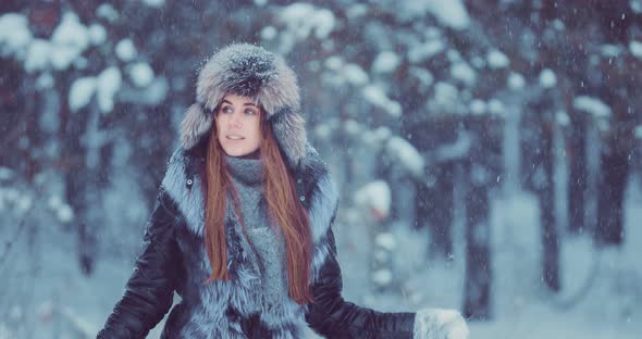 Pretty and Beautiful Woman Goes Under the Snowfall